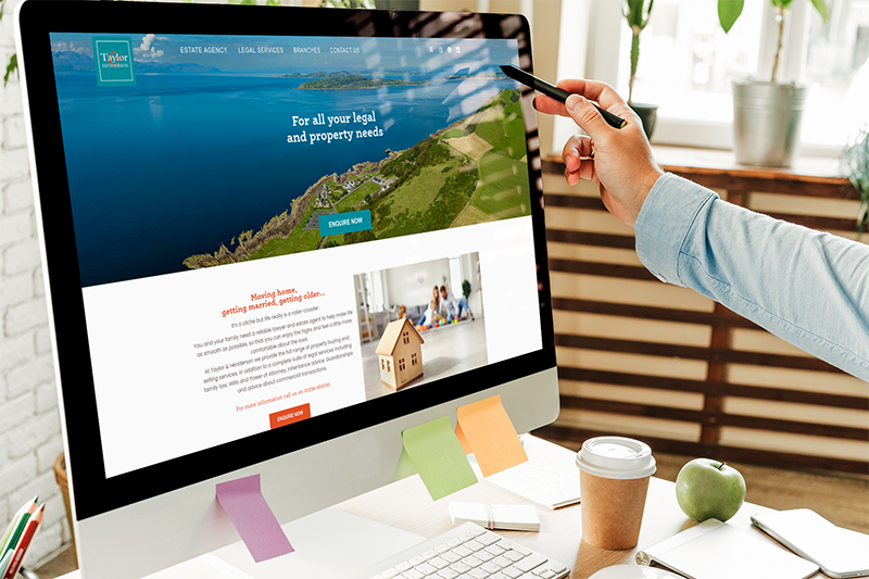 Taylor & Henderson website on an iMac in an office